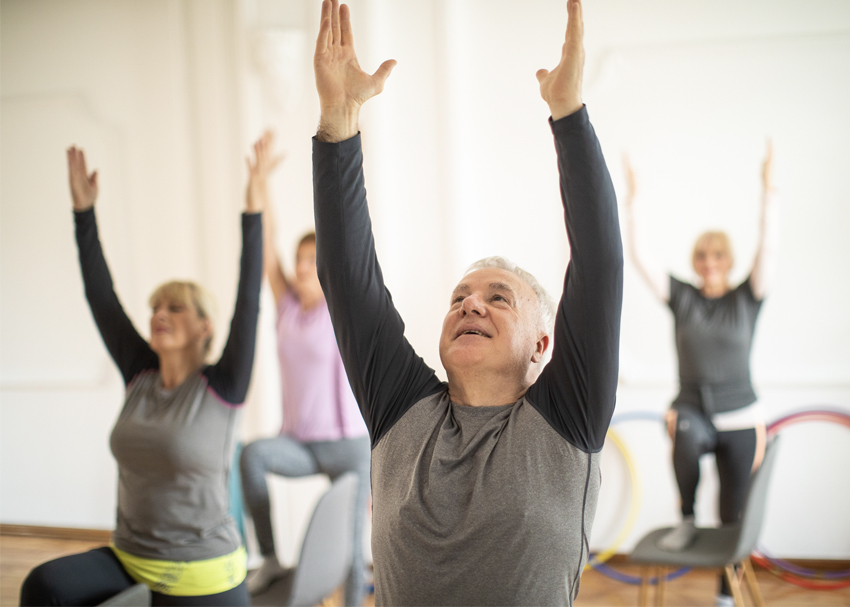 group of seniors participating in chair-fitness class