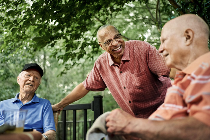 Older adults enjoying a relaxing summer day together in a senior living community